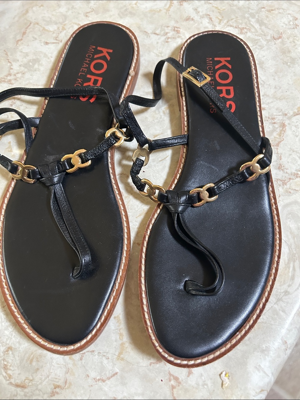 MICHAEL Michael Kors Black Leather T-Strap Sandals with Gold Chain Accents